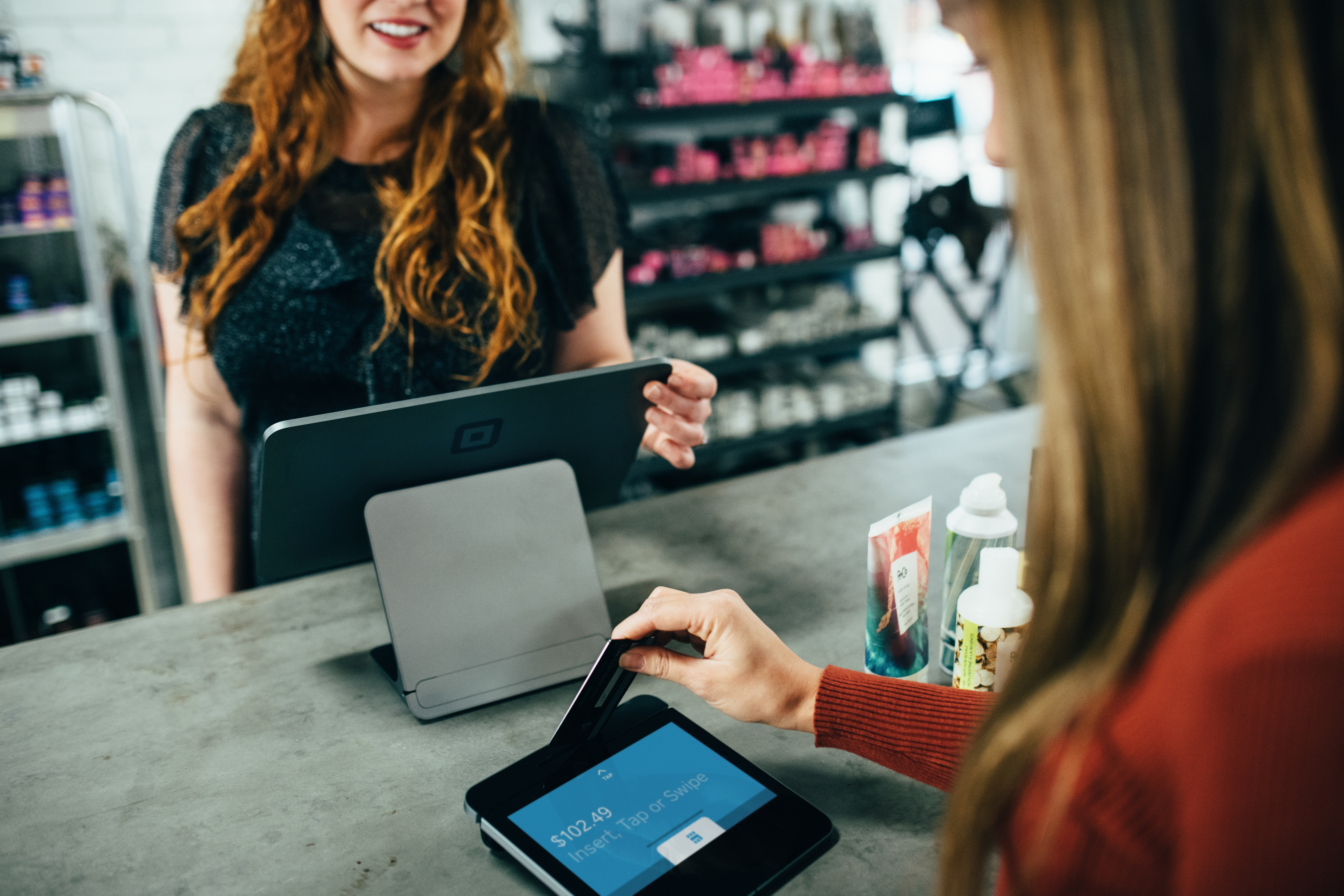 woman scanning card at checkout