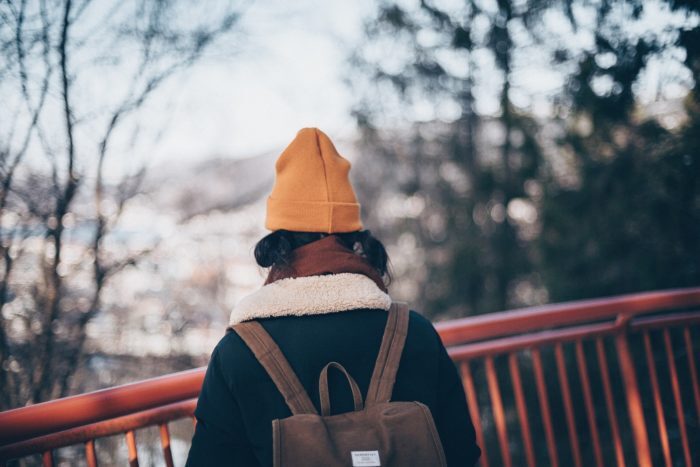 Person wearing winter coat and hat outside
